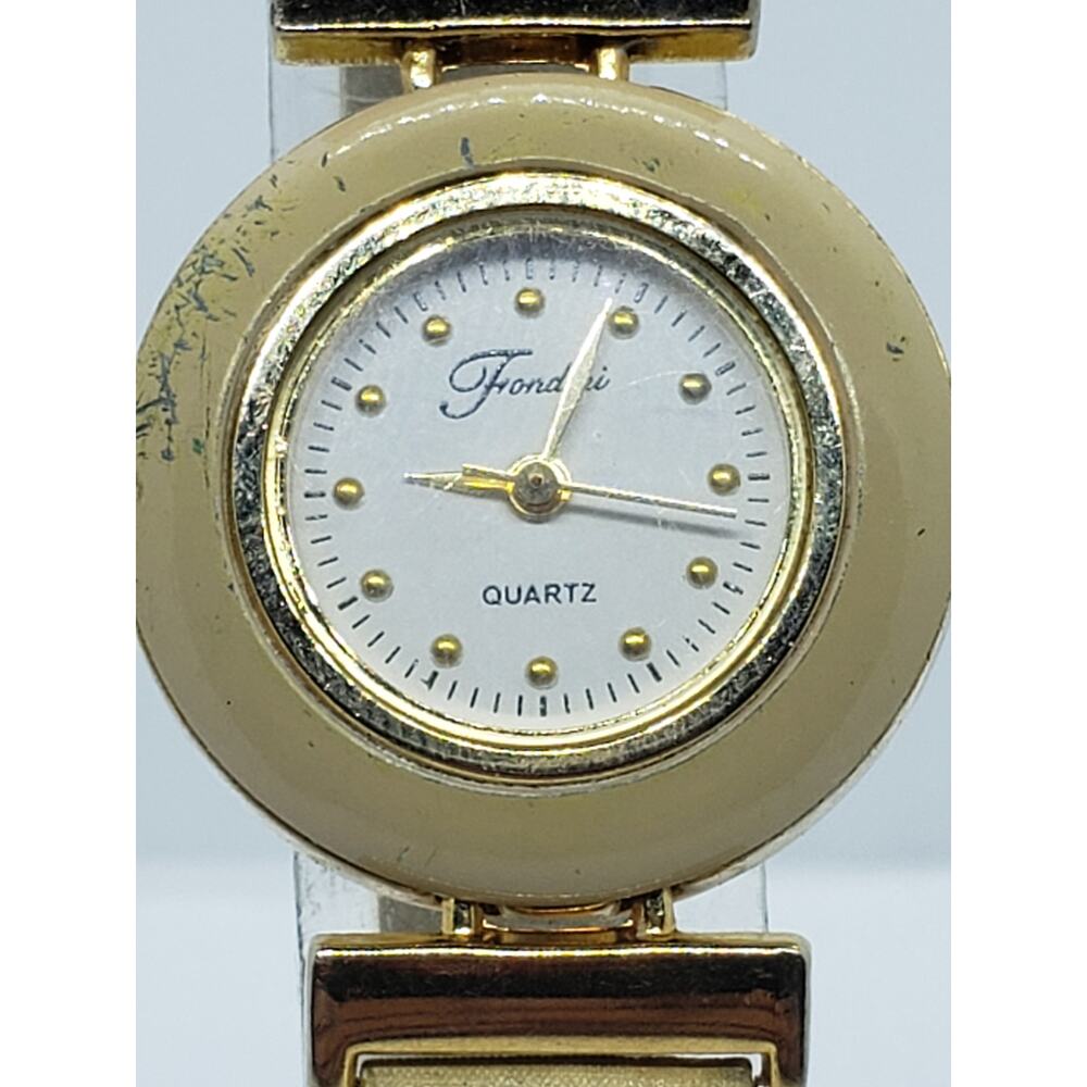 Fondini women's watch. Small white face with gold accents. Cream colored bevel